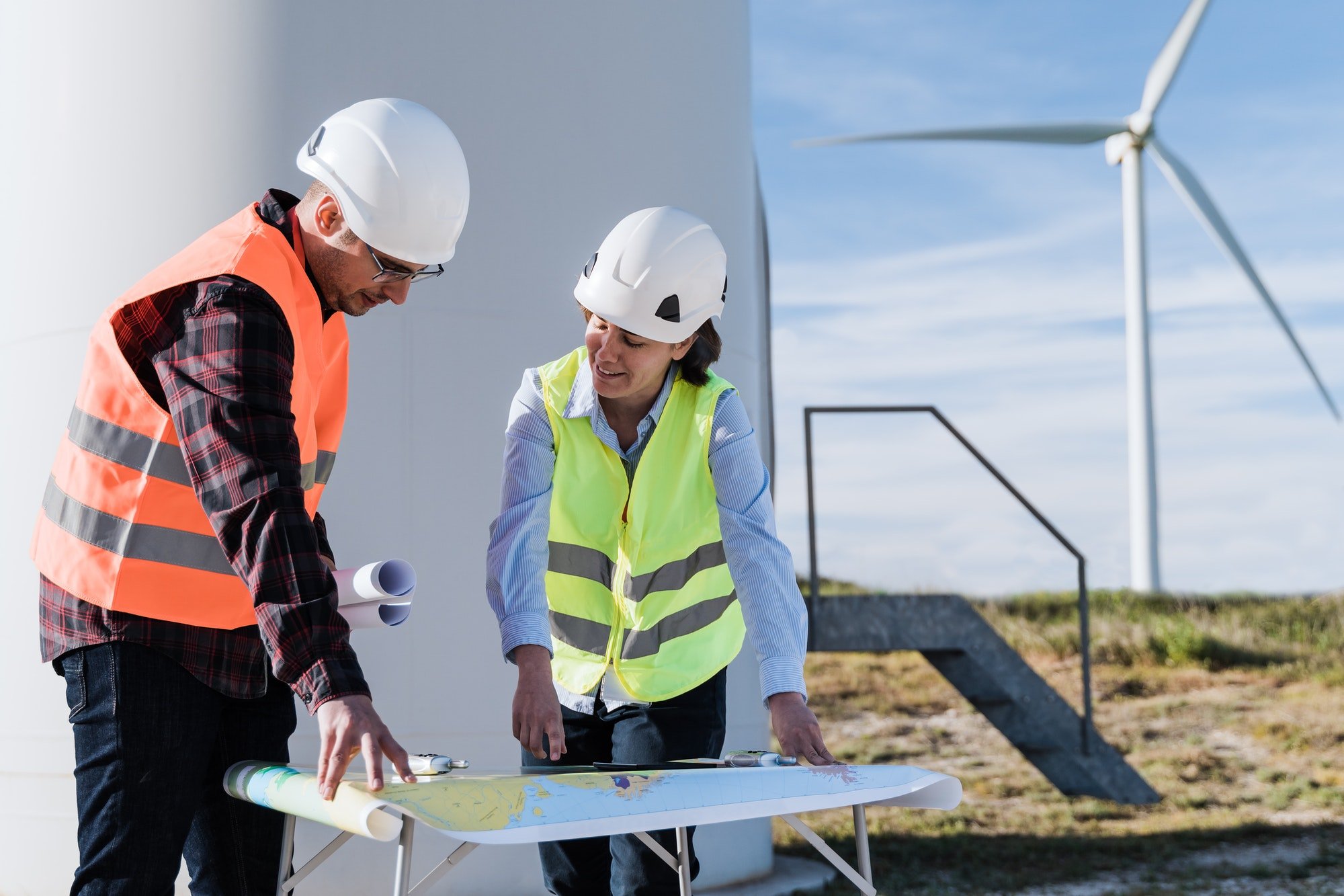 Renewable energy concept - Engineer people working at clean wind farm
