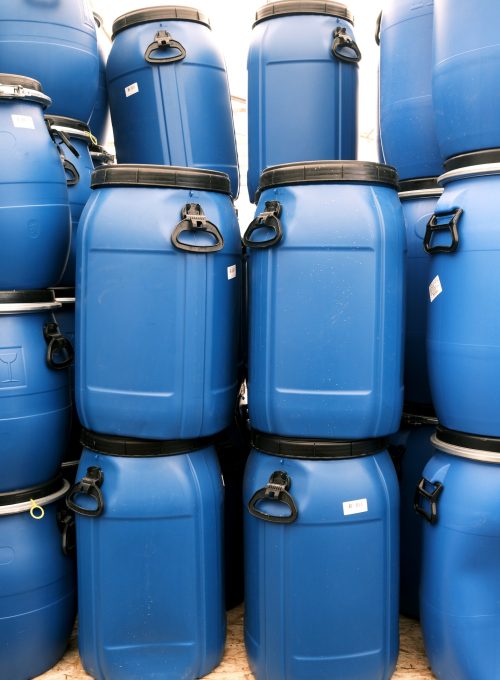 Plastic blue barrels for storing various raw materials for industry and agriculture.